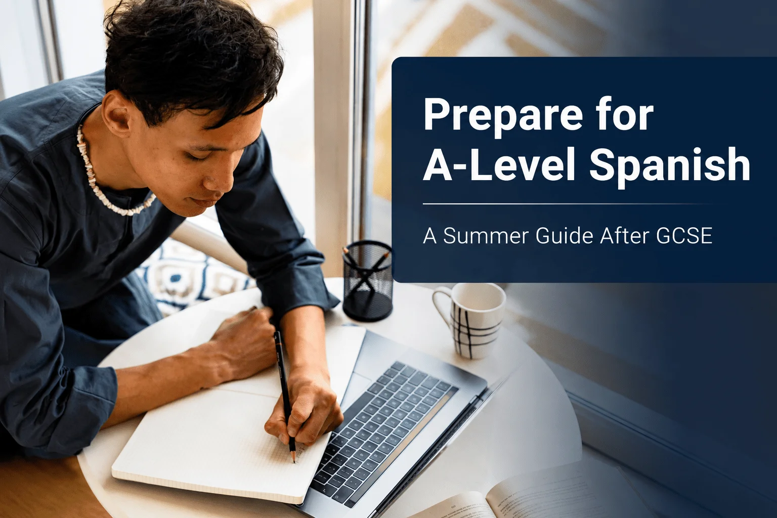 Student preparing for A-Level Spanish with a laptop and notebook
